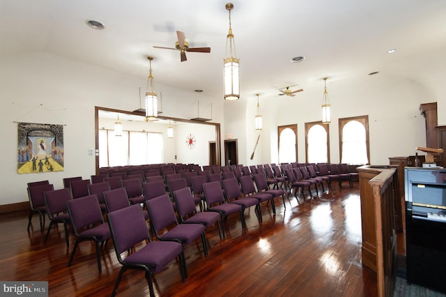 home theater room featuring hardwood / wood-style flooring and ceiling fan