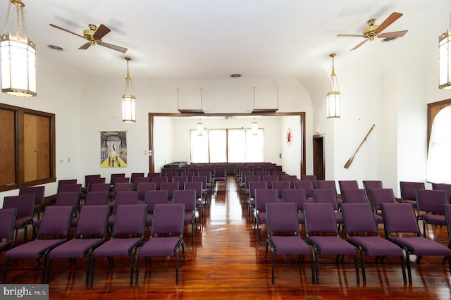 cinema with hardwood / wood-style flooring and ceiling fan