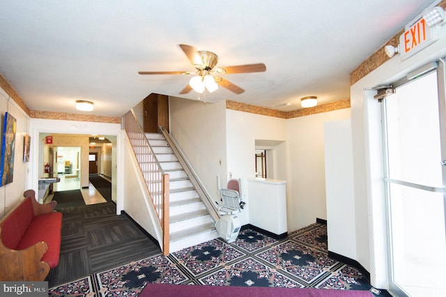 interior space with ceiling fan