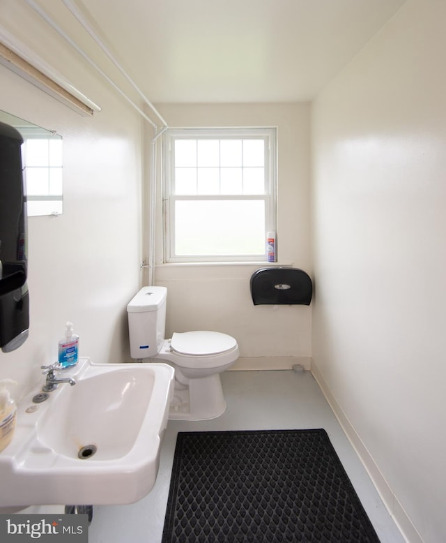 bathroom featuring sink, plenty of natural light, and toilet