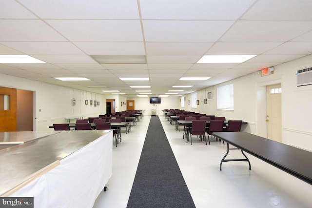 misc room featuring a paneled ceiling and a wall mounted air conditioner