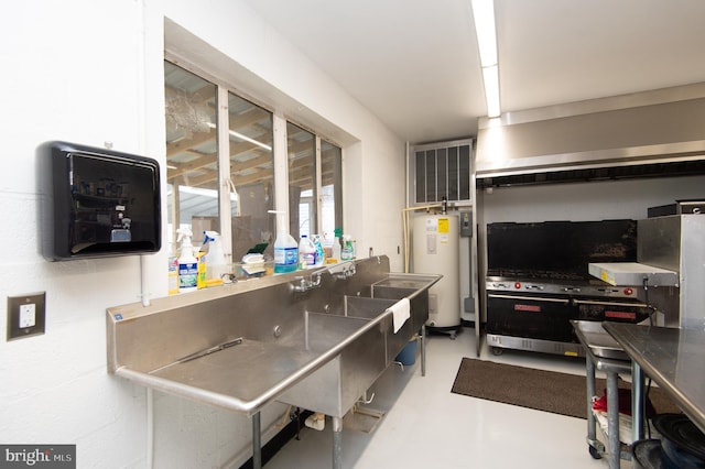 kitchen with concrete flooring and electric water heater