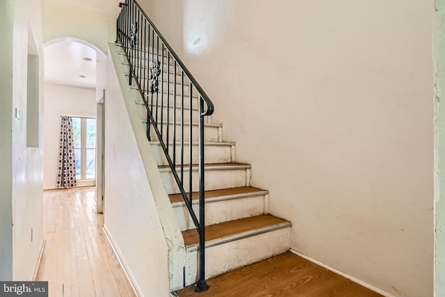 staircase with wood-type flooring