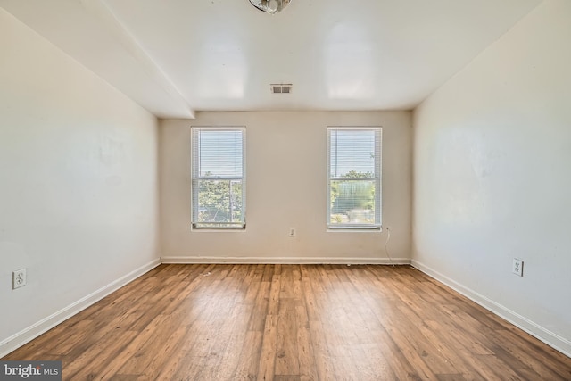 empty room with hardwood / wood-style flooring