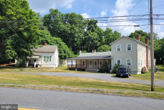 view of front of home with a porch and a front yard