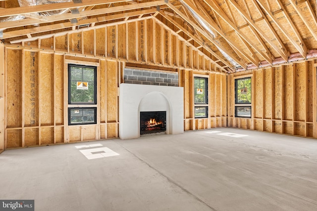 misc room with a fireplace and a towering ceiling