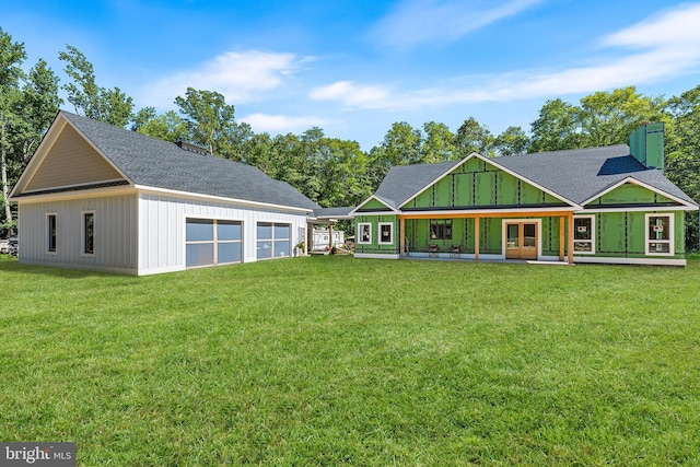 rear view of property with covered porch and a yard