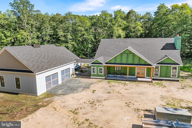 view of front of house featuring an outbuilding, a porch, and a garage