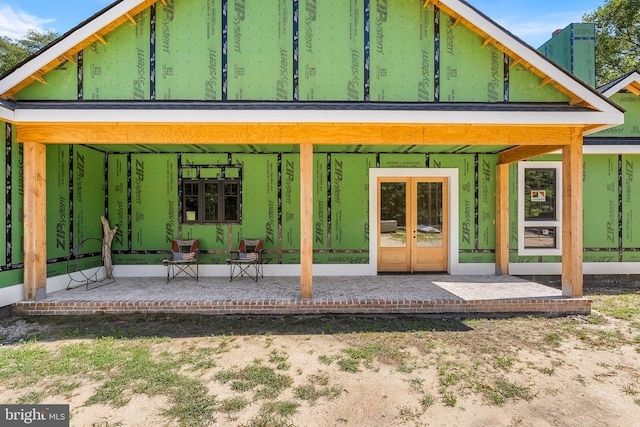 rear view of house featuring a patio and french doors