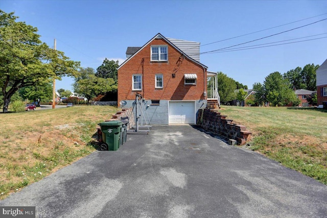 exterior space with a garage and a yard