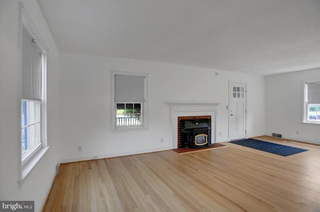 unfurnished living room with light hardwood / wood-style flooring and plenty of natural light