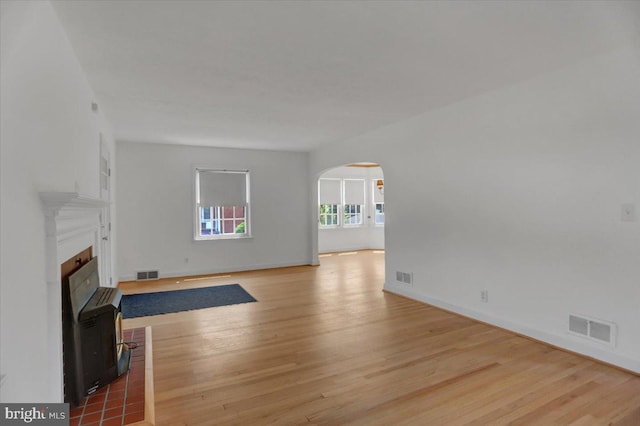 unfurnished living room with wood-type flooring