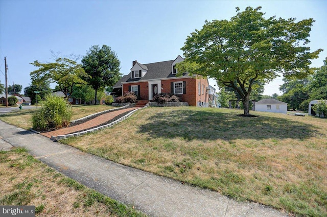 cape cod house featuring a front lawn