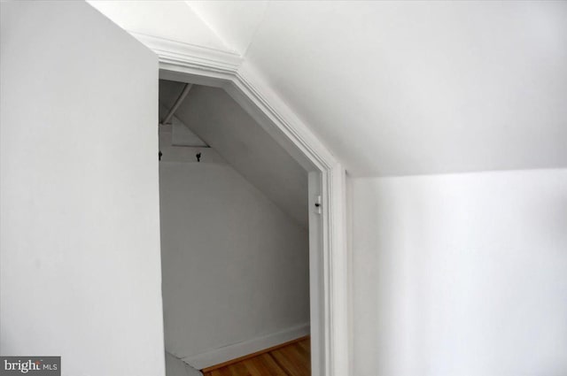 bonus room with wood-type flooring and lofted ceiling