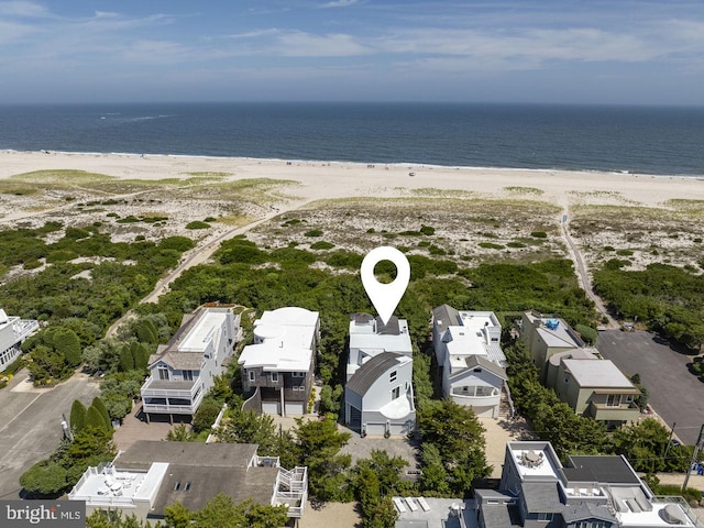 birds eye view of property with a view of the beach and a water view