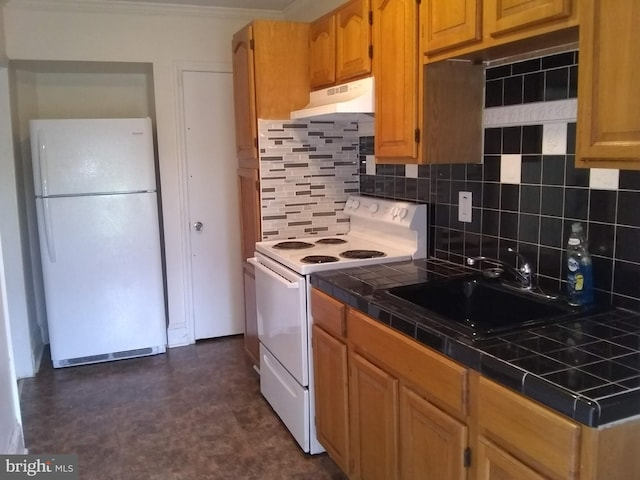 kitchen featuring backsplash, white appliances, tile counters, and sink