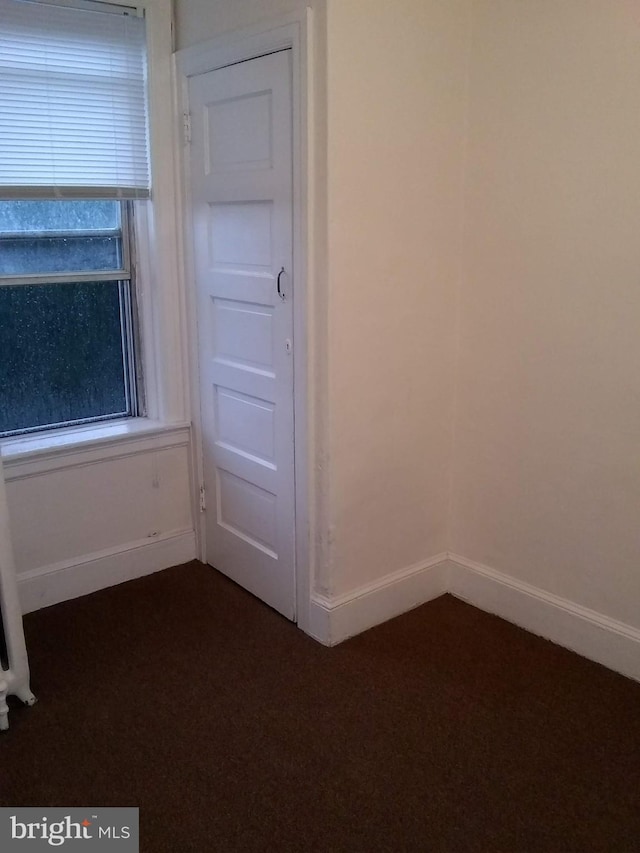 carpeted spare room featuring plenty of natural light