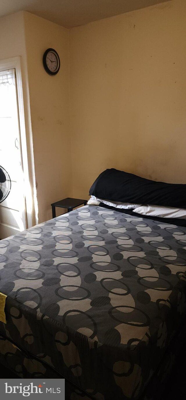 unfurnished bedroom featuring radiator heating unit, a closet, and dark colored carpet