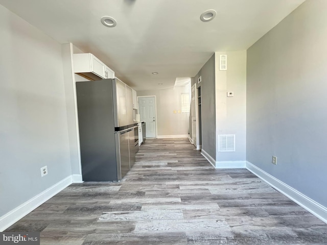 corridor with light wood-type flooring