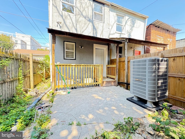 rear view of property with central air condition unit