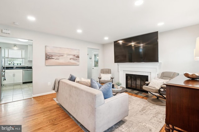 living room with sink and light wood-type flooring