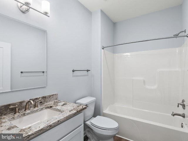 full bathroom featuring bathtub / shower combination, vanity, and toilet