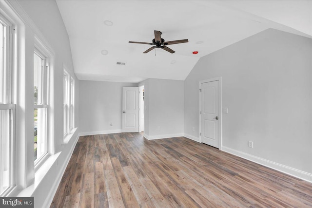 unfurnished living room featuring ceiling fan, wood-type flooring, and vaulted ceiling