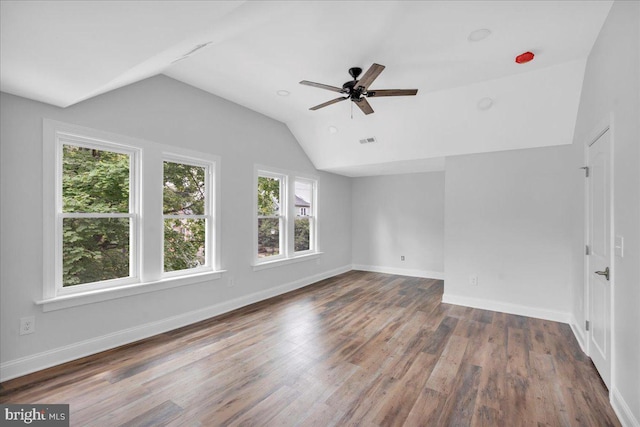 spare room with ceiling fan, hardwood / wood-style flooring, and lofted ceiling