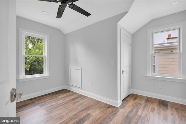 empty room featuring lofted ceiling, hardwood / wood-style flooring, and ceiling fan