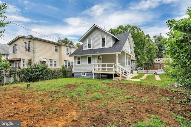 back of property with a lawn