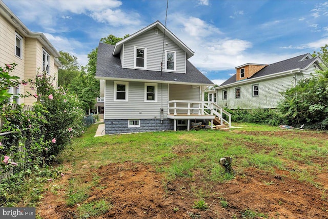 rear view of property with a lawn