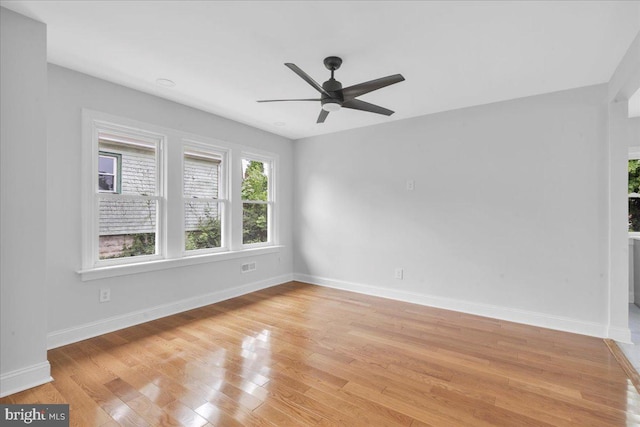 empty room with light hardwood / wood-style floors and ceiling fan