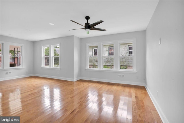 unfurnished living room with light wood-type flooring and ceiling fan