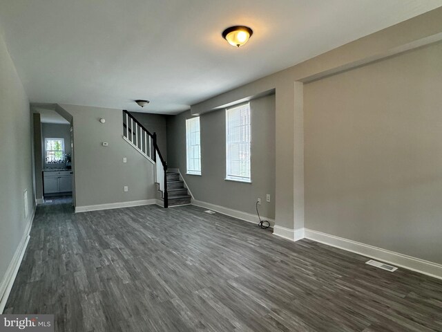 empty room with dark wood-type flooring