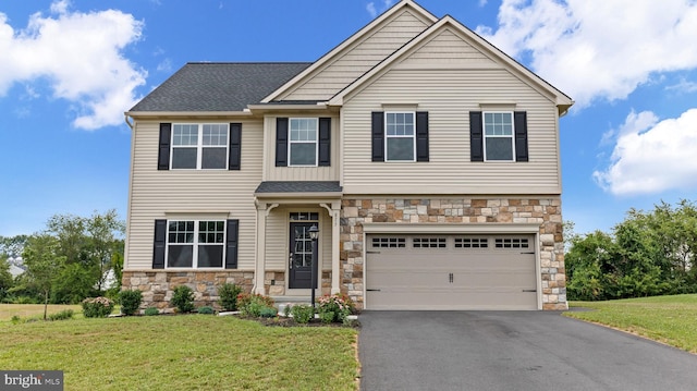 view of front of home featuring a garage and a front lawn