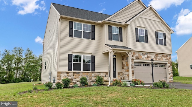 view of front of house featuring a garage and a front yard