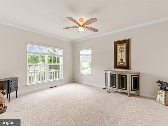 living room with light carpet, ceiling fan, and crown molding