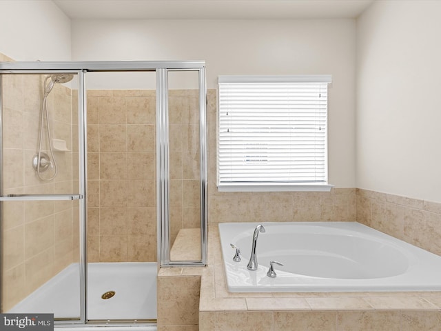 bathroom featuring separate shower and tub