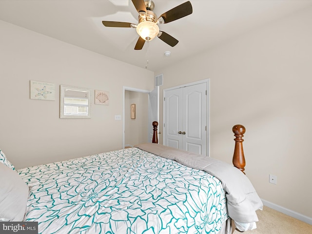 carpeted bedroom with a closet and ceiling fan