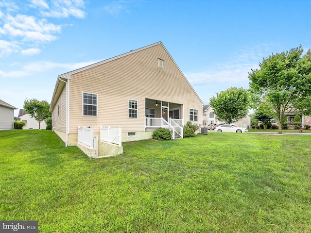 back of property featuring a lawn