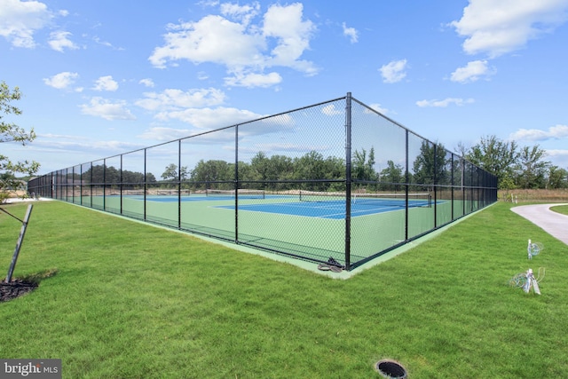 view of sport court featuring a lawn