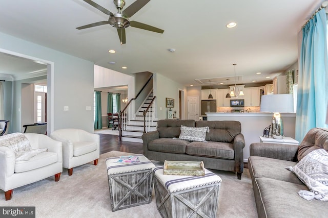 living room featuring light hardwood / wood-style flooring and ceiling fan