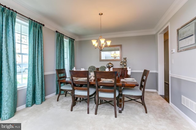 dining area featuring an inviting chandelier, carpet floors, and crown molding