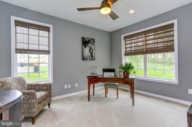 carpeted office space featuring ceiling fan