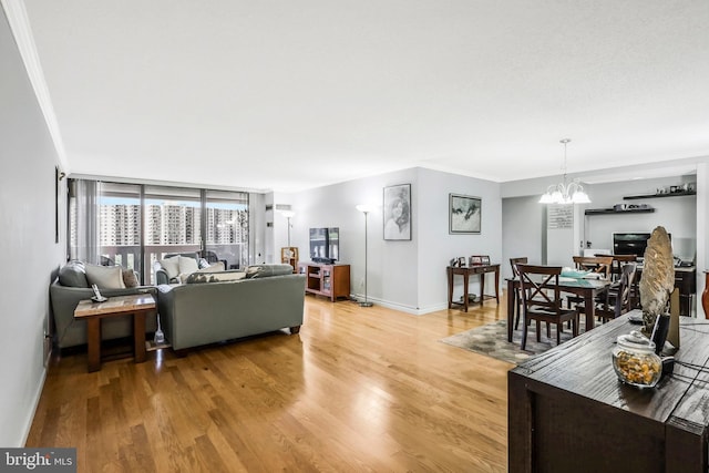 living room featuring a textured ceiling, crown molding, a chandelier, and hardwood / wood-style flooring