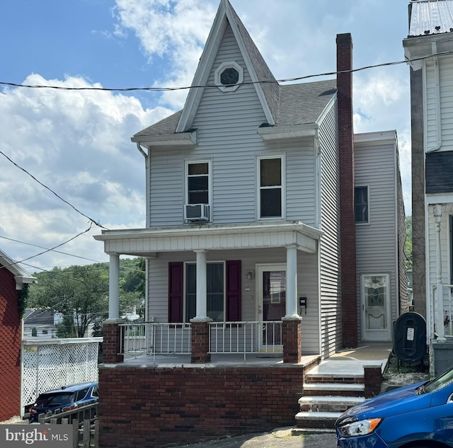 view of front facade with cooling unit and covered porch