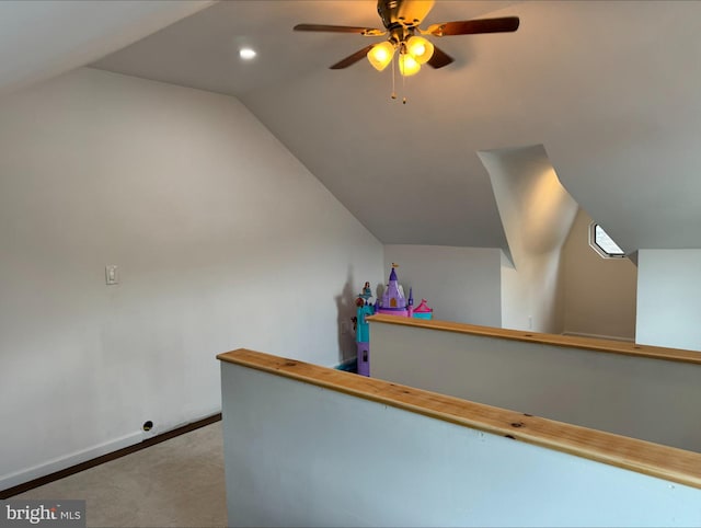 interior space with lofted ceiling, carpet, and ceiling fan