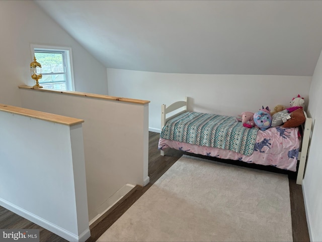 bedroom featuring vaulted ceiling and dark hardwood / wood-style flooring