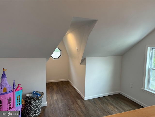 additional living space with lofted ceiling and dark wood-type flooring