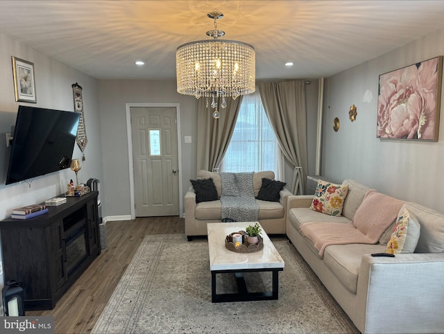 living room with hardwood / wood-style flooring and a chandelier